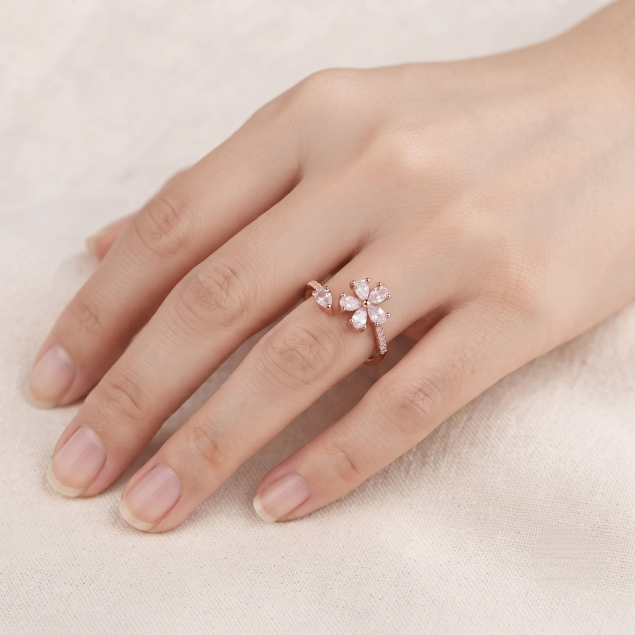 925 Sterling Silver Rose Gold Floral Open Ring with Clear CZ Stones on Gray Slate Surface.