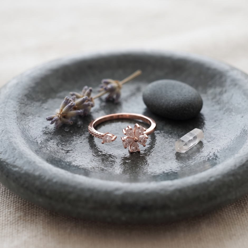 925 Sterling Silver Rose Gold Floral Open Ring with Clear CZ Stones on Gray Slate Surface.
