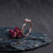 925 Sterling Silver Rose Gold Floral Open Ring with Clear CZ Stones on Gray Slate Surface.