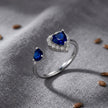 925 Sterling Silver Open Heart Ring with Blue CZ and Clear Halo Accent.