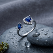 925 Sterling Silver Open Heart Ring with Blue CZ and Clear Halo Accent.
