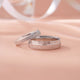 Two silver rings on a soft pink background
