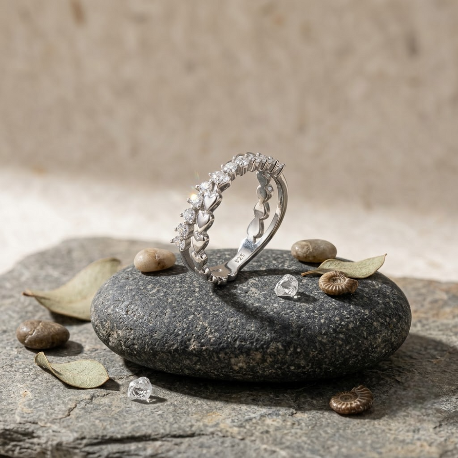 25 Sterling Silver Floral Heart Eternity Ring with Clear Cubic Zirconia Stones on a Black Slate Display.