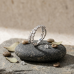 25 Sterling Silver Floral Heart Eternity Ring with Clear Cubic Zirconia Stones on a Black Slate Display.