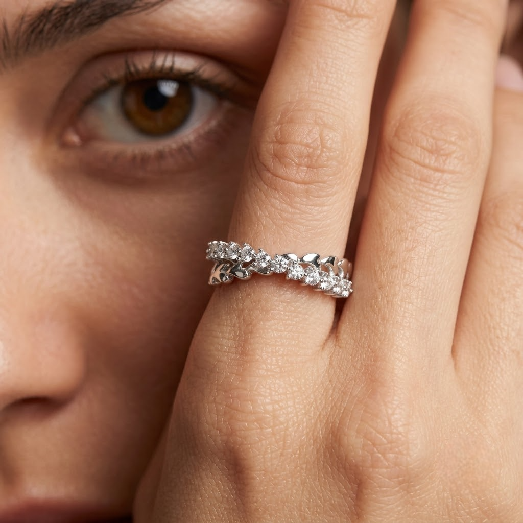 25 Sterling Silver Floral Heart Eternity Ring with Clear Cubic Zirconia Stones on a Black Slate Display.