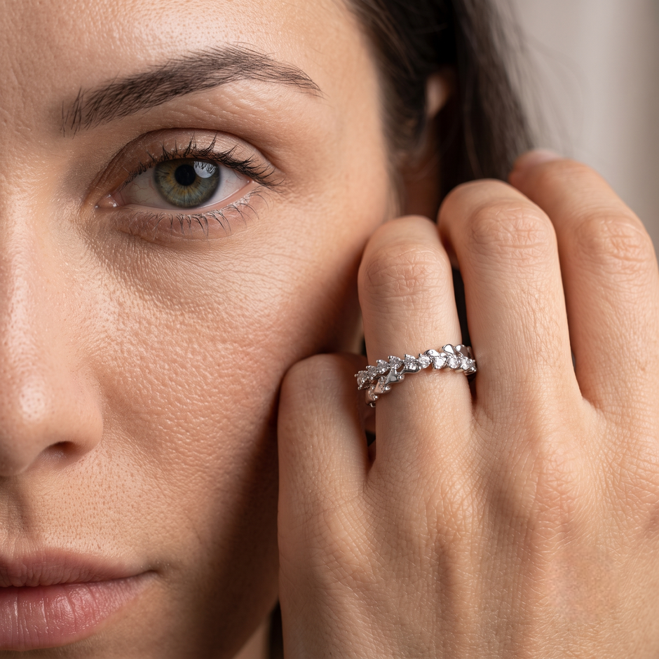 25 Sterling Silver Floral Heart Eternity Ring with Clear Cubic Zirconia Stones on a Black Slate Display.