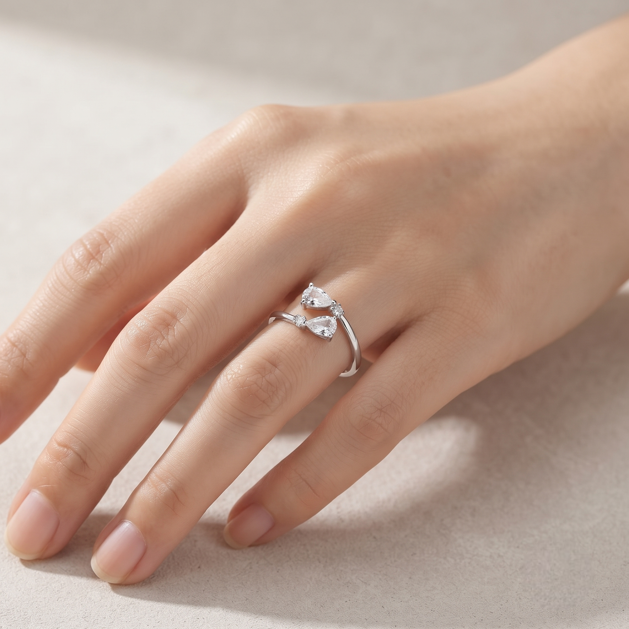 925 Sterling Silver Pear Cut CZ Open Ring with Round Accent Stones.