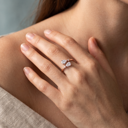 925 Sterling Silver Rose Gold Open Ring with Dual Pear Cut CZ Stones and Round Accents on Natural Stone.