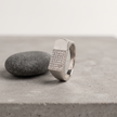 Silver ring with a rectangular pavé-set face and wide polished band.