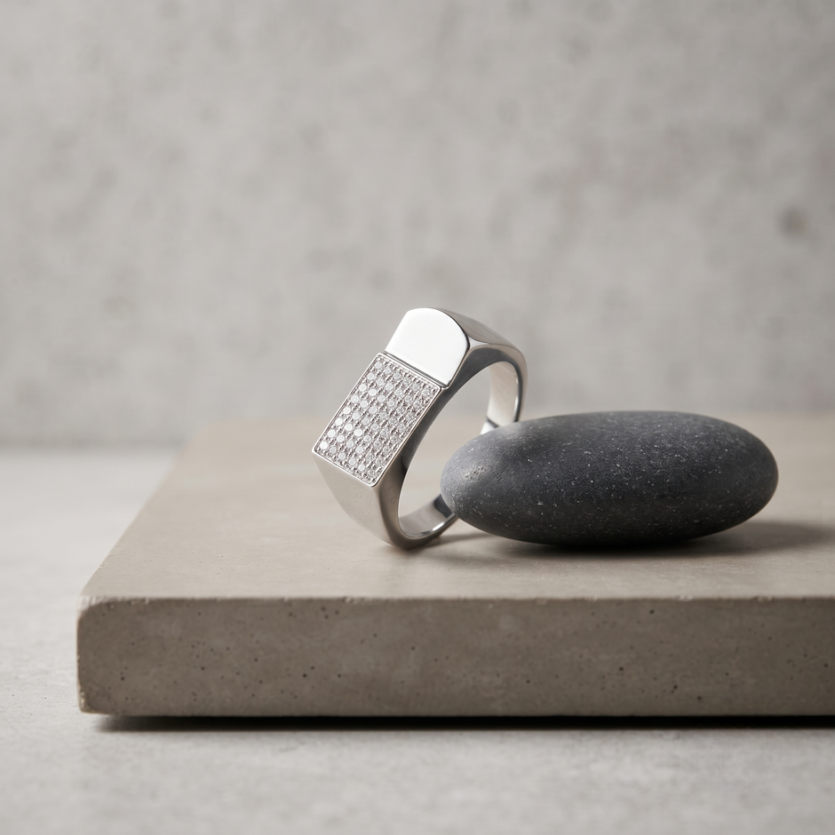 Silver ring with a rectangular pavé-set face and wide polished band.