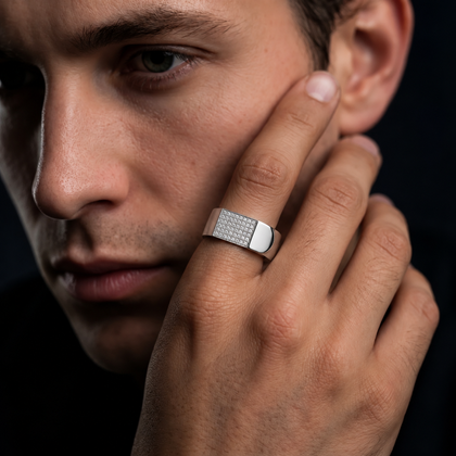 Silver ring with a rectangular pavé-set face and wide polished band.