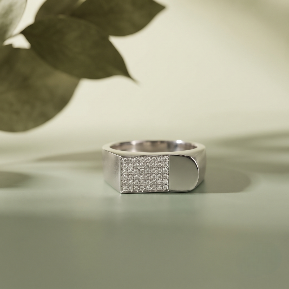 Silver ring with a rectangular pavé-set face and wide polished band.