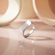 Silver ring with a rectangular pavé-set face and wide polished band.