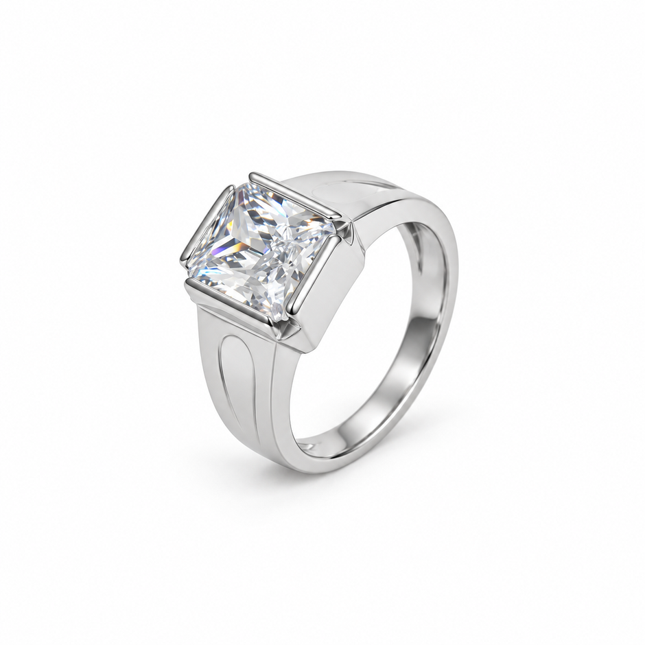 Silver ring with a large rectangular clear stone and engraved geometric band.