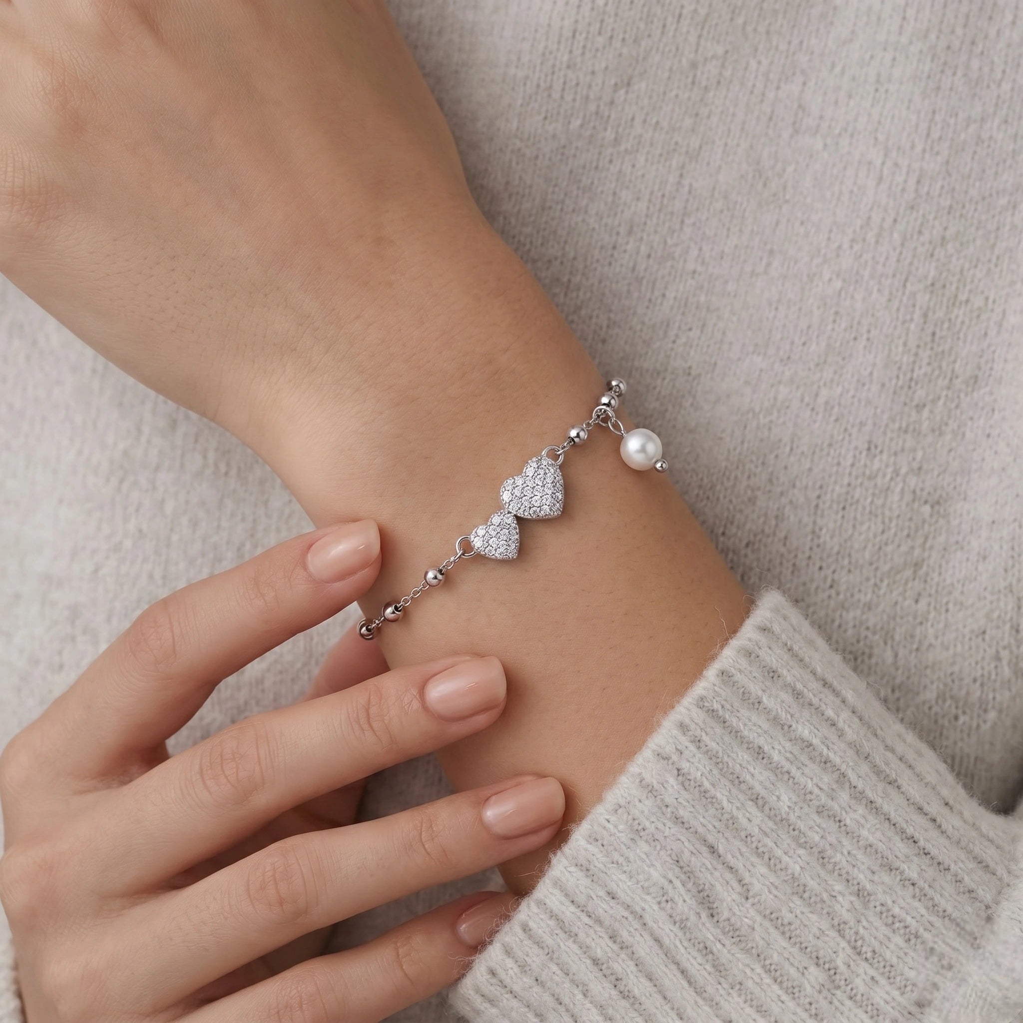 925 Sterling Silver Bracelet with Double CZ Heart Charms, Pearl Drop, and Beaded Chain on White Background