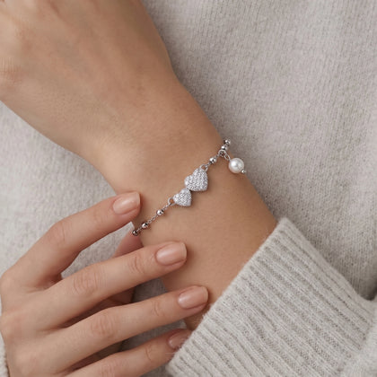 925 Sterling Silver Bracelet with Double CZ Heart Charms, Pearl Drop, and Beaded Chain on White Background