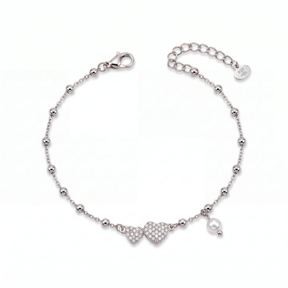 925 Sterling Silver Bracelet with Double CZ Heart Charms, Pearl Drop, and Beaded Chain on White Background