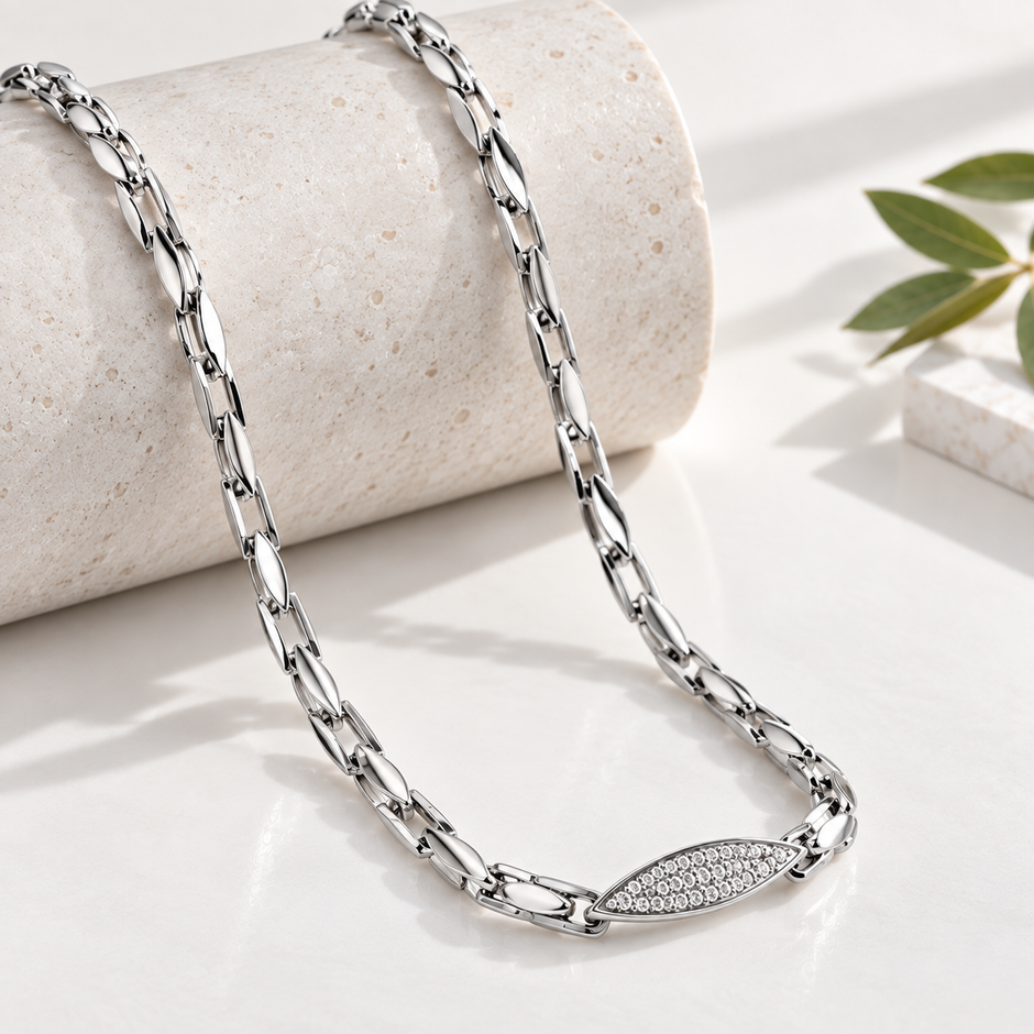 Silver paperclip chain with an oval stone-studded centrepiece.