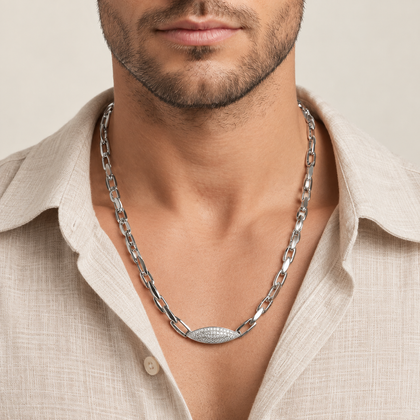Silver paperclip chain with an oval stone-studded centrepiece.