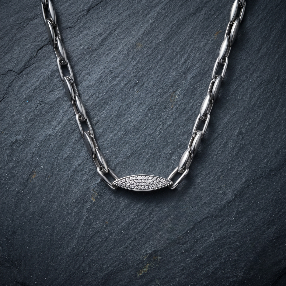 Silver paperclip chain with an oval stone-studded centrepiece.