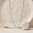 Silver chain with alternating polished cylindrical links and stone-studded barrel accents.