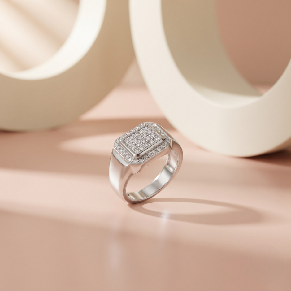 Silver ring with a square pavé-set centre, stone-studded halo and wide polished band.