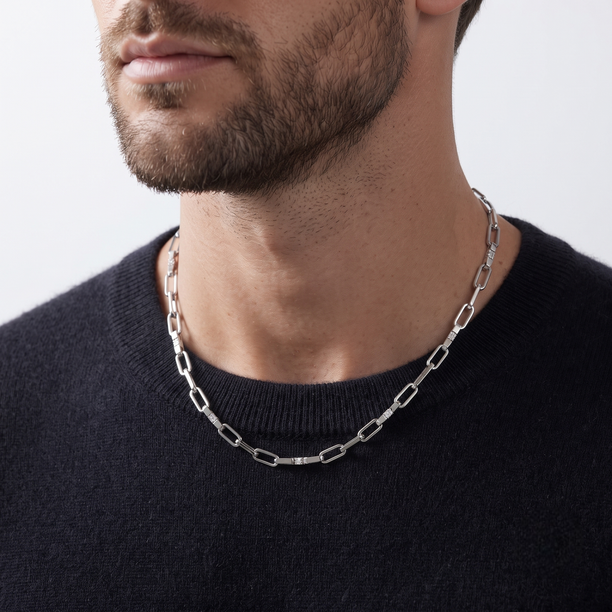 Silver rectangular-link chain with sparkling stone-set accents.