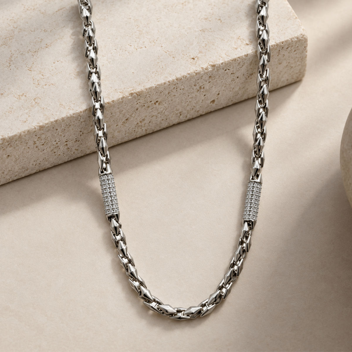 Silver link chain with stone-studded accents.