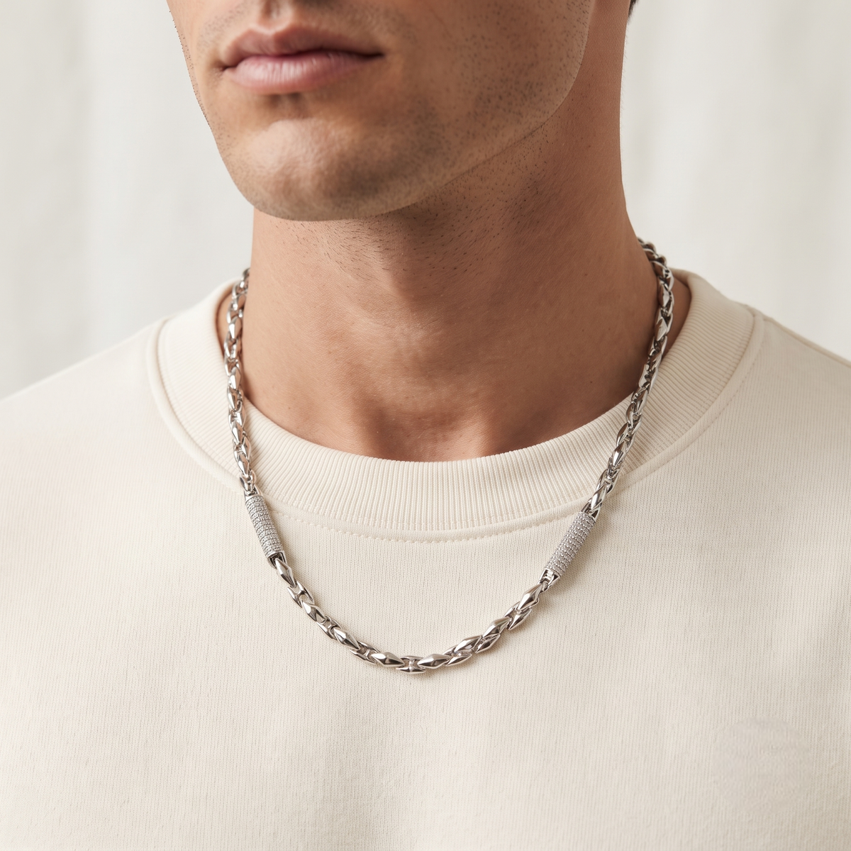 Silver link chain with stone-studded accents.