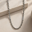 Silver link chain with stone-studded accents.