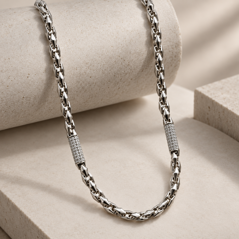 Silver link chain with stone-studded accents.