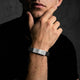 Man wearing a bracelet with a dark background