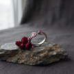 925 Sterling Silver Open Heart Ruby CZ Adjustable Ring on Natural Stone with Red Roses.