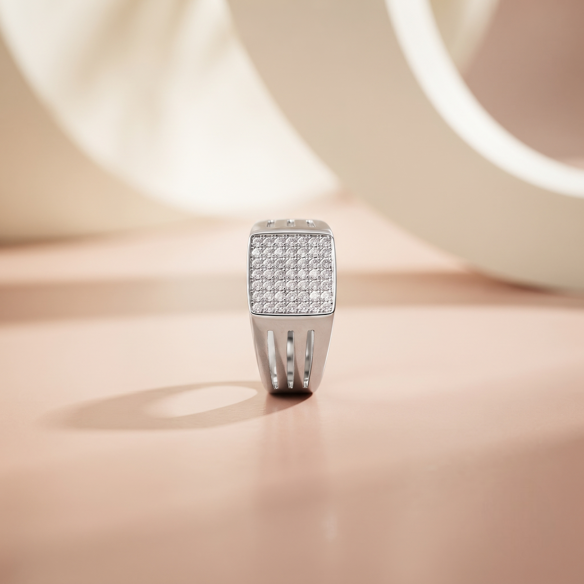 Silver ring with a square pavé-set face and open slotted band.