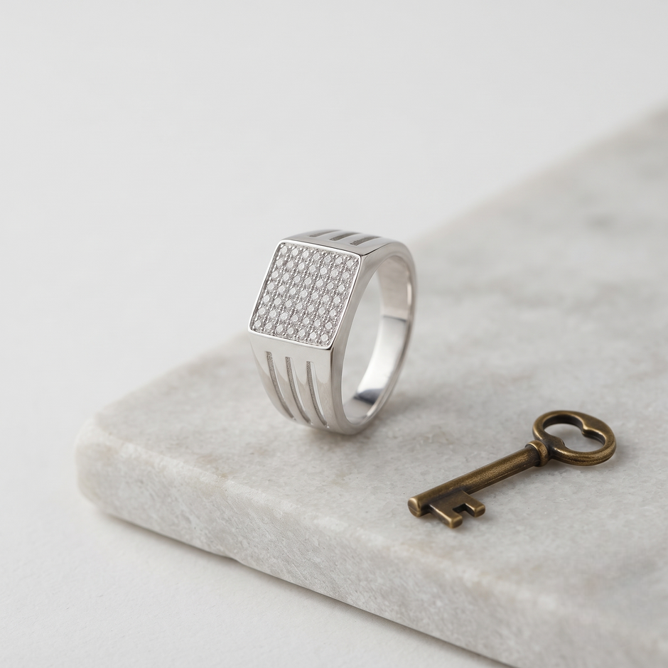 Silver ring with a square pavé-set face and open slotted band.