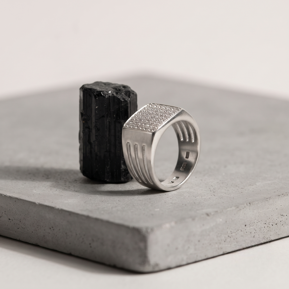Silver ring with a square pavé-set face and open slotted band.