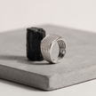 Silver ring with a square pavé-set face and open slotted band.