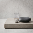 Silver ring with a square pavé-set face and open slotted band.