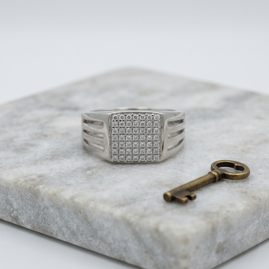 Silver ring with a square pavé-set face and open slotted band.