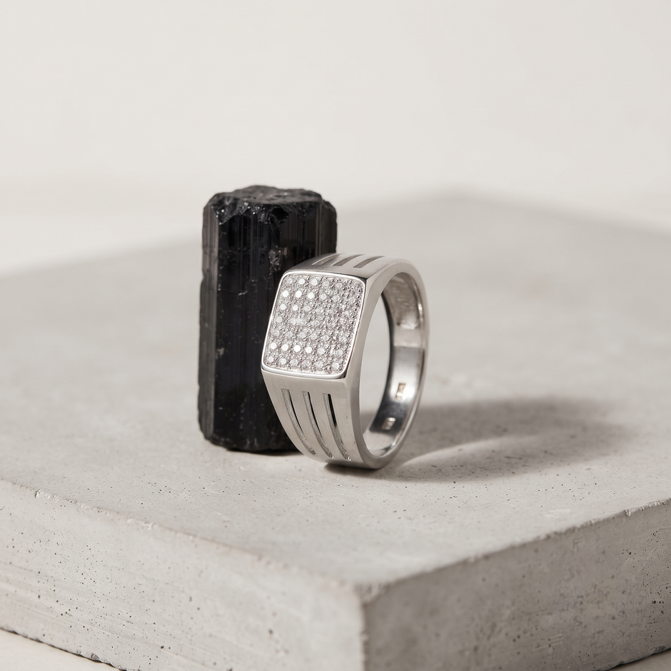 Silver ring with a square pavé-set face and open slotted band.