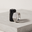 Silver ring with a square pavé-set face and open slotted band.