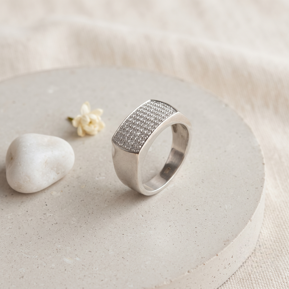 Silver ring with a broad rectangular pavé-set face and polished band.