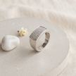 Silver ring with a broad rectangular pavé-set face and polished band.