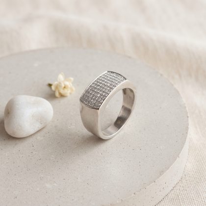 Silver ring with a broad rectangular pavé-set face and polished band.
