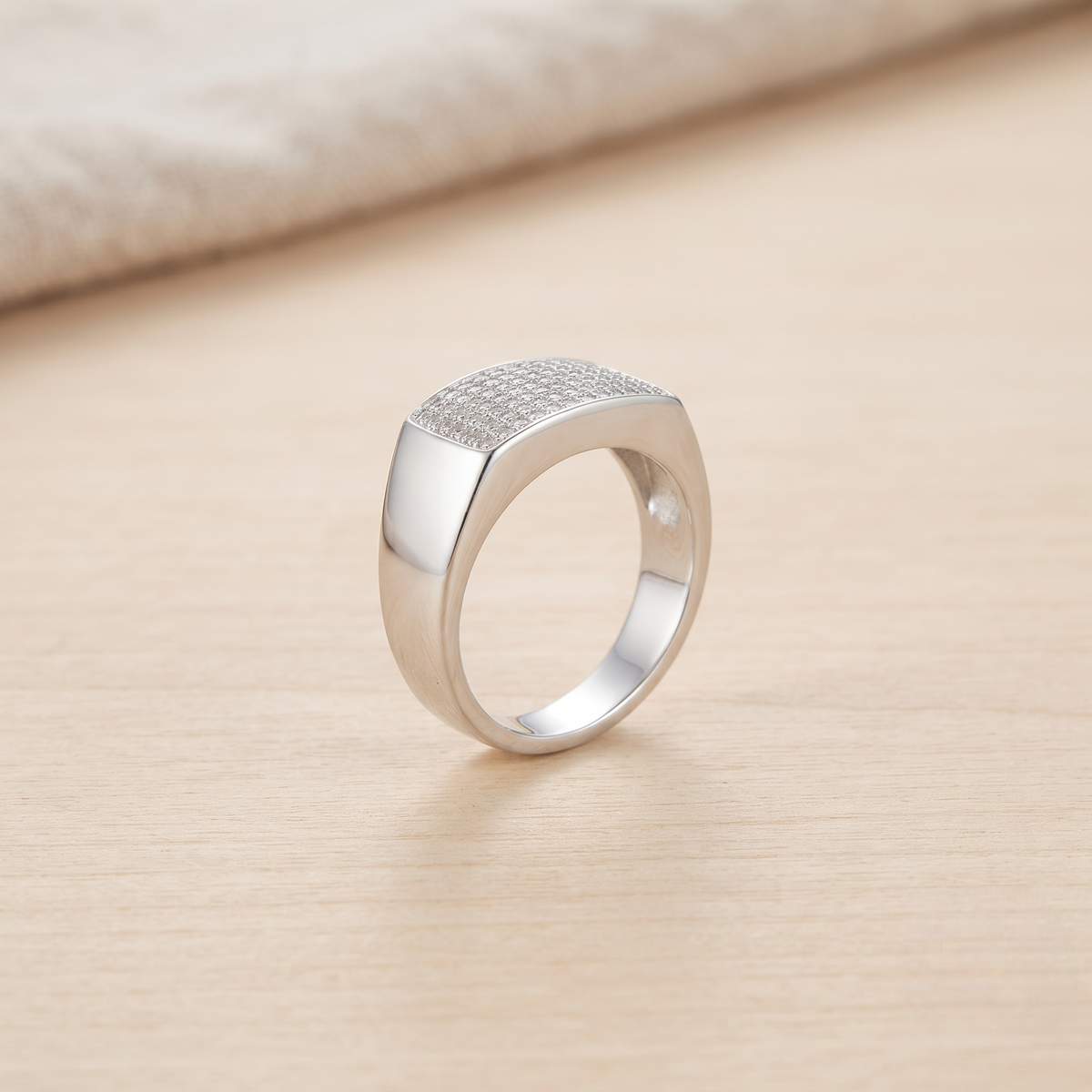 Silver ring with a broad rectangular pavé-set face and polished band.