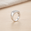 Silver ring with a broad rectangular pavé-set face and polished band.