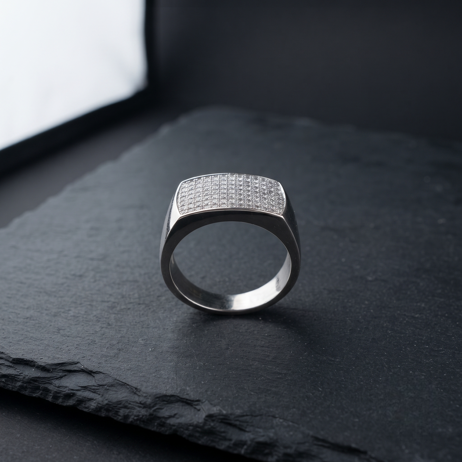 Silver ring with a broad rectangular pavé-set face and polished band.
