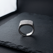 Silver ring with a broad rectangular pavé-set face and polished band.