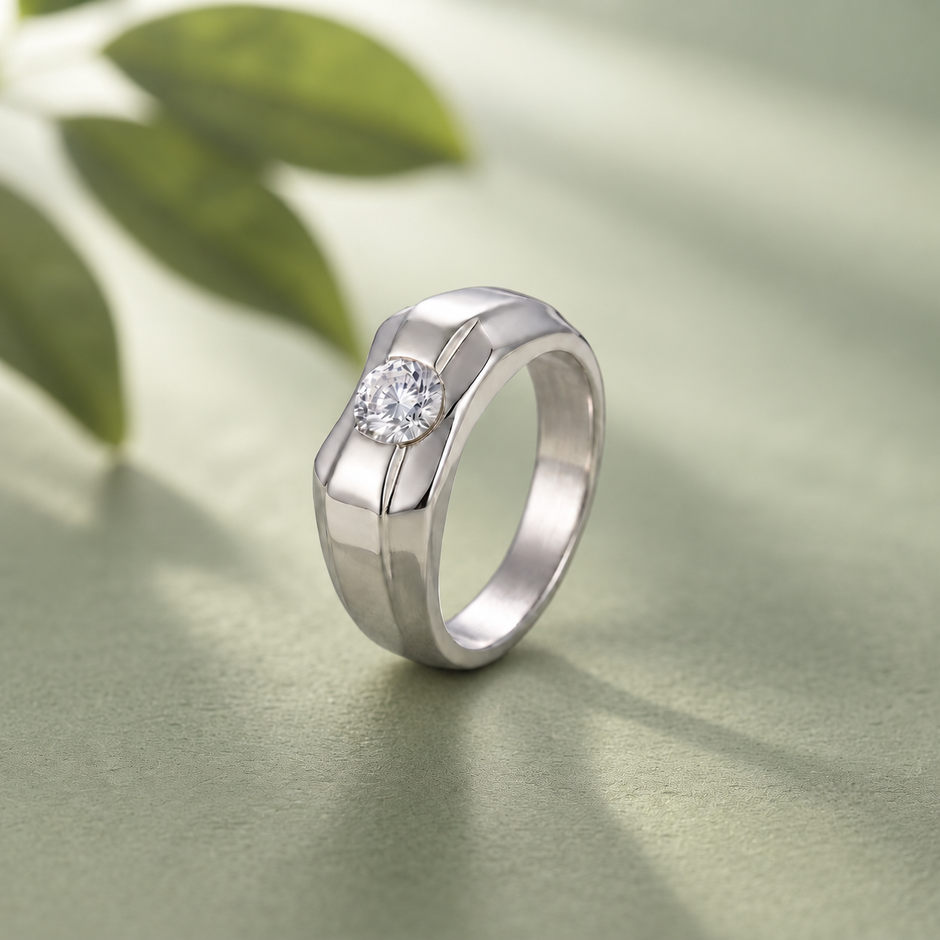 Silver ring with a round clear centre stone and a wide geometric band.