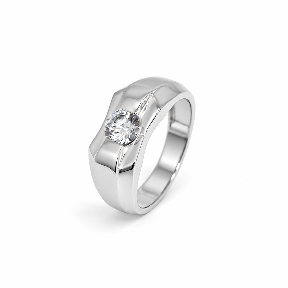 Silver ring with a round clear centre stone and a wide geometric band.